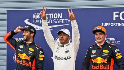 Mercedes-GP driver driver Lewis Hamilton, cente, celebrates after taking pole position for Sunday's Italian Formula One Grand Prix. Luca Bruno / AP Photo