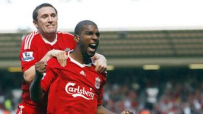 The Dutch forward Ryan Babel is hugged by a joyful Robbie Keane after netting the winning goal against Manchester United at Anfield.