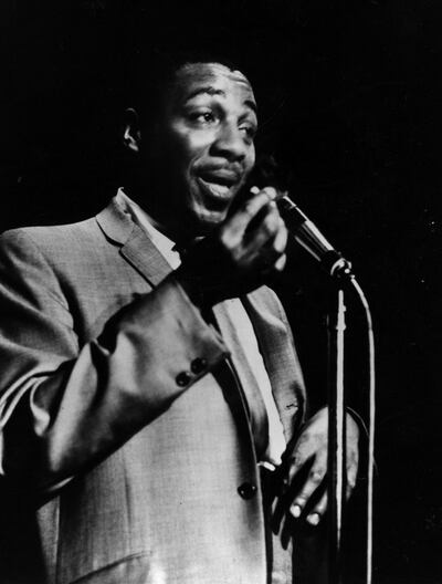 Black comedian Dick Gregory at the microphone, 1962. Getty Images