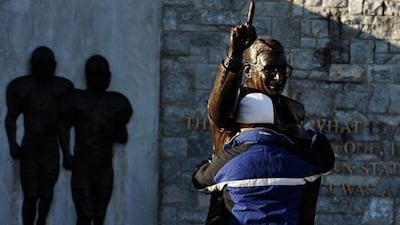 A fan pays respects to a statue of former Penn State football coach Joe Paterno, who was fired from his post fired amid allegations that Jerry Sandusky, the former Penn State defensive coordinator was involved with child sex abuse.