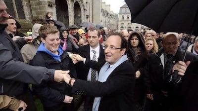 France's Socialist Party candidate for the 2012 French presidential election Francois Hollande shakes hands with supporters during a campaign visit in the western city of Quimper, on April 23, 2012. Socialist challenger Francois Hollande won the first round of the French presidential vote, on April 22, 2012, setting himself up for a May 6 run-off with right-wing incumbent Nicolas Sarkozy.