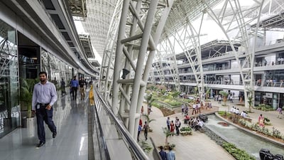 Employees walk along a corridor as others gather in a rest area at the Tata Consultancy Services campus in Chennai, India. IT outsourcing companies in India, including Infosys, Tata Consultancy Services and Wipro, are heavily dependent on revenues from the US. Dhiraj Singh / Bloomberg