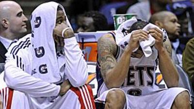Courtney Lee, the New Jersey Nets guard, right, alongside Terrence Williams, sums up his team's season as he looks down in disbelief during their 100-90 loss to the Toronto Raptors last week.