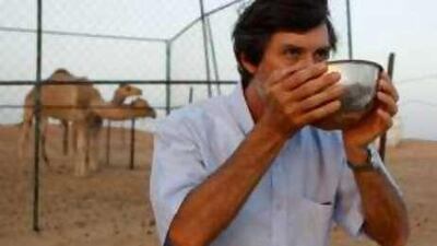 Bill Jones, a professor of health and nutrition, drinks fresh camel milk at a friend's farm near Al Ain.