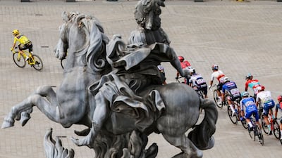 Jumbo-Visma's Danish rider Jonas Vingegaard rides past the Louvre in Paris. AFP