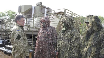Ukraine’s president Petro Poroshenko talks to servicemen at a military camp near the town of Svyatogorsk June 20, 2014 during his first visit to eastern Ukraine since taking office. Mykhailo Markiv / Ukrainian Presidential Press Service / Reuters