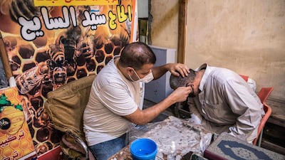 Apitherapist Sayed Al Sayeh treats a patient with bee sting therapy at his practice in Giza. AFP
