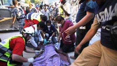 Mexican and Israeli medics apply first aid to Josyanne Petidelle after she was rescued from the rubble in Port-au-Prince on January 15, 2010. Ms Petidelle was declared dead but was discovered to still be alive when a Mexican rescue worker felt her throat.