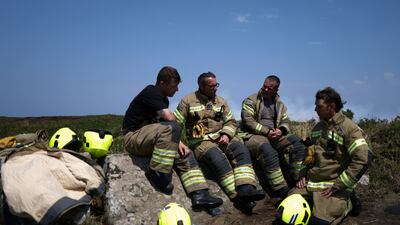 Firefighters rest after attending a gorse bush fire near Zennor in Cornwall. Reuters