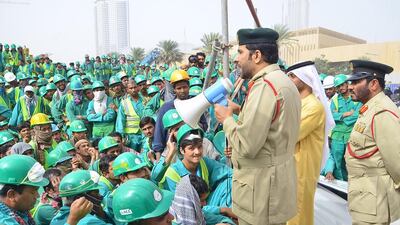 Lt Col Sultan Al Jammal, of the Human Trafficking unit at Dubai Police’s Department of Human Rights, addresses the workers. Courtesy Dubai Police