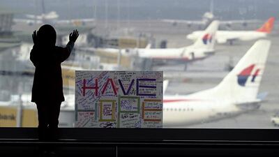 A sign at Kuala Lumpur International Airport carries messages of hope for the Malaysian Airlines Boeing 777 that went missing on Saturday. Daniel Chan / AP Photo / March 10, 2014
