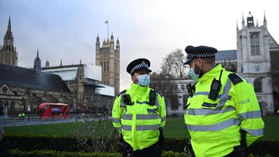 Police on guard outside parliament in London. EPA