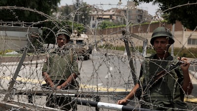 Soldiers of the Egyptian Republican Guard on duty at the gates of Egypt's Presidential Palace in the suburb of Heliopolis.Egypt's military moved to tighten its control of key institutions Wednesday, putting officers in the newsroom of state TV, in prepara???