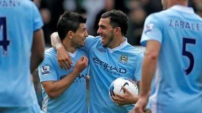 Carlos Tevez, right, has scored four goals in his last two games alongside his Argentina teammate Sergio Aguero, left. The two are likely to start up front against Wolves today at Molineux. Ian Kington / AFP