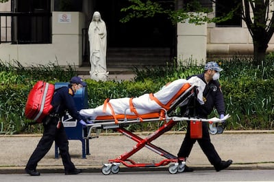 A patient is transported from the Terence Cardinal Cooke health care centre on the upper east side in New York, 9 May. Peter Foley / EPA