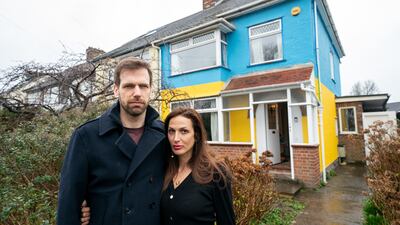 Rend Platings and her husband Michael outside their home in Cambridge on Wednesday, which they have painted in the colours of the Ukraine flag in a show of support for friends in the country. PA