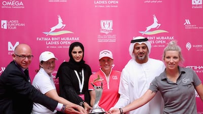Annika Sorenstam, in pink, and others show off the trophy for the Fatima bint Mubarak Ladies Open. Photo Courtesy / FBM Ladies Open