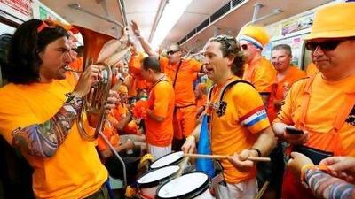Supporters of the Holland team make some noise in a train near Kharkiv railway station. Ukraine railways are doing well out of the fans. Jerry Lampen / EPA