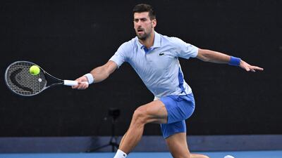 Novak Djokovic hits a return against Taylor Fritz during their quarter-final in Melbourne. AFP