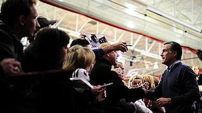 Mitt Romney greets supporters after addressing a rally on Saturday in New Hampshire, which holds its Republican primaries today.