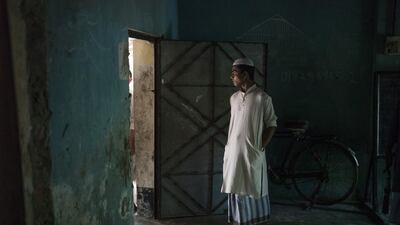 A Bangladeshi man stands in a room where bodies of Rohingya Muslim refugees are being brought on Shah Porir Dwip Island near Teknaf on October 9, 2017, after a boat capsizing accident. Fred Dufour / AFP