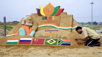 Artist Ajay Rawat creates a sand sculpture in the desert of Pushkar, India while the 18th Brics Summit was being held 460km away in New Delhi. AFP