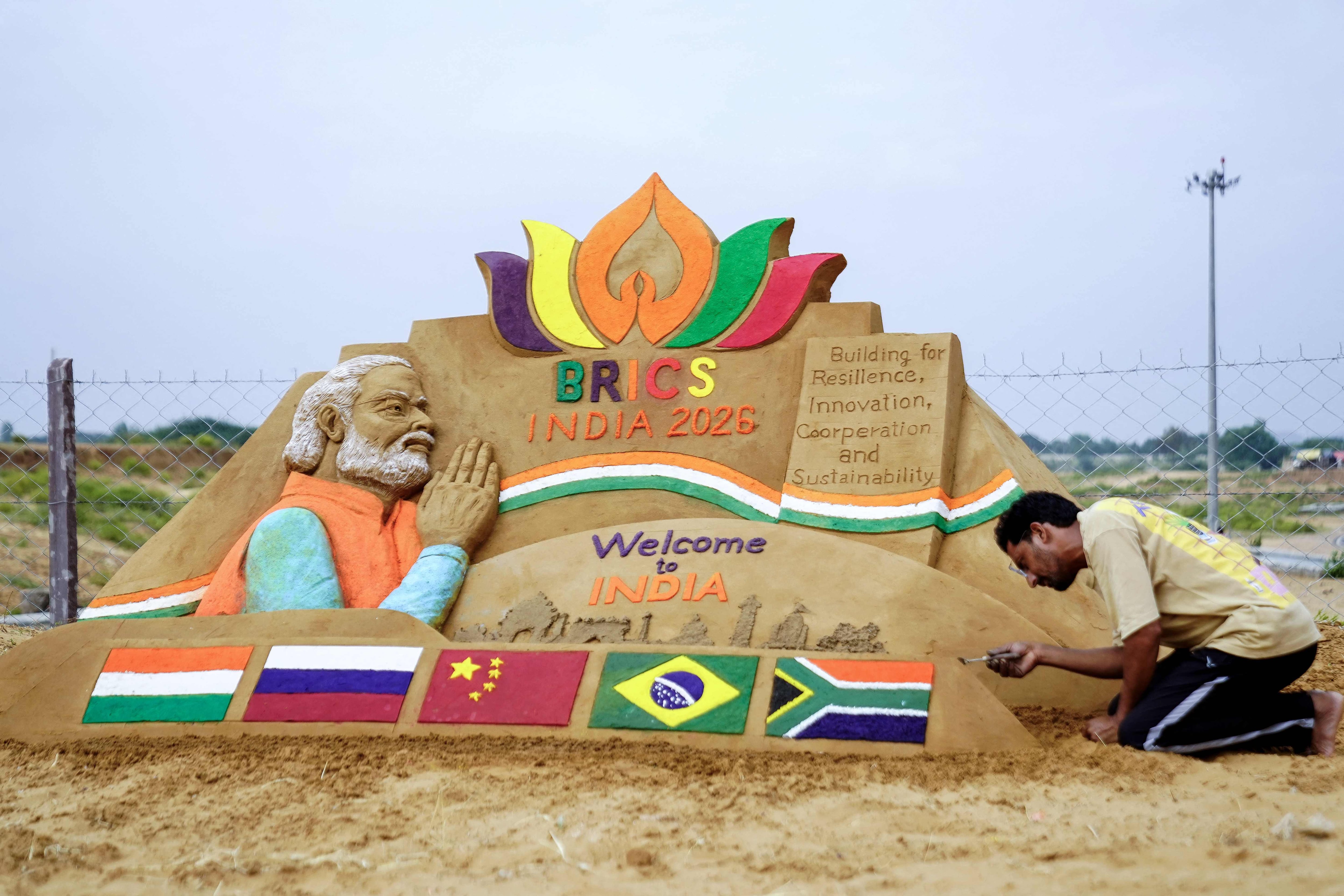 Artist Ajay Rawat creates a sand sculpture in the desert of Pushkar, India while the 18th Brics Summit was being held 460km away in New Delhi. AFP
