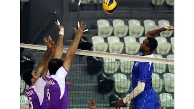 Al Nasr’s Mohammed Abbas, 16, sets a pass to Fasal Darwish at the net against Al Ain in the Zayed Cup in Abu Dhabi last night. Al Ain won 25-22, 25-15, 25-22 to advance to the semi-finals.