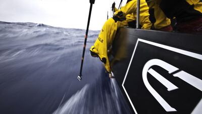Craig Satterthwaite from New Zealand hangs over the side to tighten up some bolts in the damaged hull area while being filmed by a GoPro camera on a pole, during leg 5 of the Volvo Ocean Race 2011-2012. Nick Dana / Abu Dhabi Ocean Racing / Volvo Ocean Race photo via AP Images
