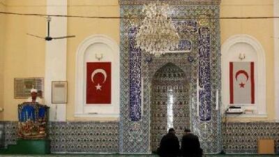 Turkish Cypriot men, with the flags of Turkey and breakaway Turkish Cypriot state on the wall, listen to an imam at a mosque during Friday prayers in Famagusta's Tatlisu village, in the Turkish-administered northern part of Cyprus, April 16, 2010. Turkish Cypriots vote in an election on Sunday that diplomats fear could scupper chances of a peace deal on the ethnically-split island and further hamper Turkey's chances of joining the European Union.