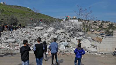Palestinians stand by the rubble of buildings demolished by Jerusalem municipality workers, reportedly built without an Israeli construction permit, in East Jerusalem, February 22, 2021. AFP