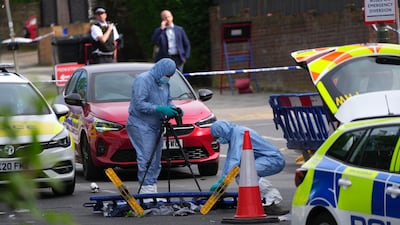 A forensic police officer photographs the scene. Getty Images