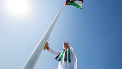 Jaber Al Suwaidi, General Director of the Crown Prince Court - Abu Dhabi, raises the UAE flag during a Flag Day ceremony, at the Crown Prince Court of Abu Dhabi. Hamad Al Kaabi / Crown Prince Court - Abu Dhabi