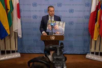Israel's ambassador to the UN, Gilad Erdan, holds a picture of Yaakov and Asher Palley, who were killed by a Palestinian attacker this month. AFP