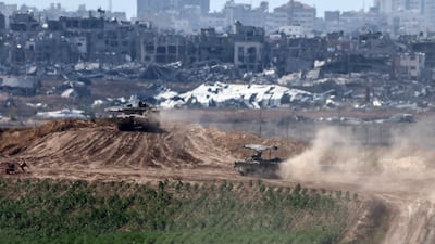 Israeli tanks manoeuvre along the border with the Gaza Strip, near the Palestinian city of Jabalia. EPA