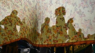 Hindu pilgrims dry their clothes after taking a holy dip at the confluence of the Ganges and the Bay of Bengal during the Gangasagar Mela ahead of the Makar Sankranti, at Sagar Island, about 150km south of Kolkata, India. AFP