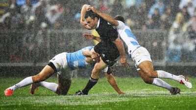 All Blacks left wing Julian Savea scores a try as he is tackled by Argentina's right wing Horacio Agulla in Napier. Marty Mleville / AFP