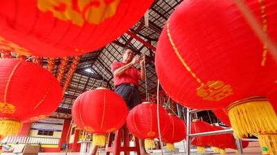 A man prepares decorative Chinese lanterns at a temple in Tangerang, Indonesia. EPA
