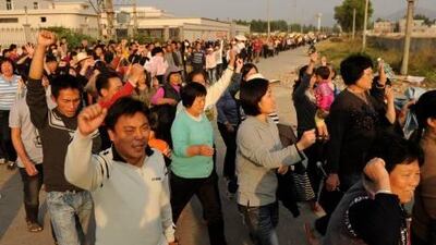 Residents of Wukan, a fishing village in the province of Guangdong, march to demand the government take action over land grabs and the death in custody of a local leader. Thousands of residents of a Chinese village under police blockade rallied December 15 to demand the government take action over illegal land grabs and the death in custody of a local leader.