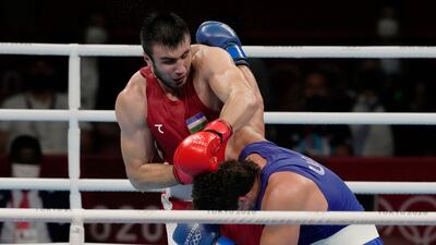Uzbekistan's Bakhodir Jalalov, top, exchanges punches with Richard Torrez Jr from the United States during their men's super heavyweight over 91-kg boxing gold medal match.