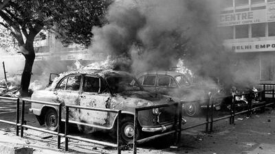 A fleet of Sikh owned cars burn after being set on fire by rioting Hindus in downtown New Delhi on November 1, 1984, near Parliament Square. Violence all over the country and in the capital broke out following the killing of Prime Minister Indira Gandi. Peter Kemp / AP