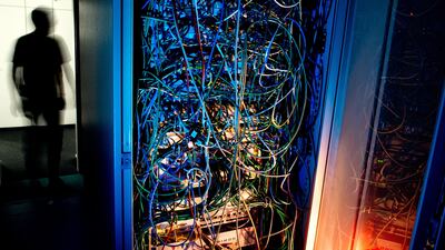 An employee works in a server room in Hanover, Germany. Data centres provide storage space and computing resources but demand a lot of energy. EPA