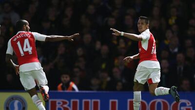 Arsenal’s Alexis Sanchez celebrates with Theo Walcott after opening the scoring for the team on Saturday against Watford. Jan Kruger / Getty Images