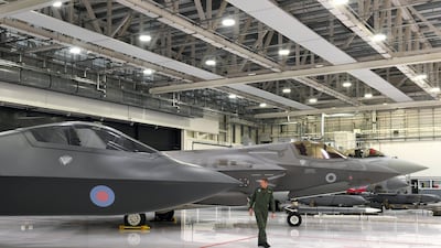 Tempest Programme Director Jez Holmes inspects a prototype of a Tempest fighter jet at RAF Marham in Norfolk. Alamy