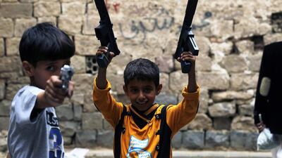Yemeni children pose with toy guns they got as a gift for Eid Al Fitr, during the Muslim festival of Eid Al Fitr in the narrow streets of the old city of Sana’a, Yemen. Yahya Arhab / EPA
