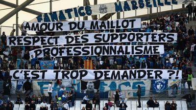 Marseille fans hold a banner reading "for the love of the OM jersey, the respect of fans and professionalism, is it too much to ask?", before the start of the French Ligue 1 match against Caen at the Stade Velodrome on November 5, 2017. Boris Horvat / AFP