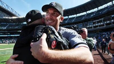 Chicago White Sox starting pitcher Phil Humber, front right, is embraced after pitching a perfect baseball game against the Seattle Mariners.