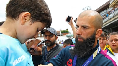 Moeen Ali of England signs a autograph during the England ICC World Cup Victory Celebration at The Kia Oval, England. Getty Images