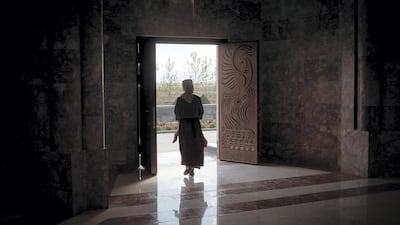 A worshipper leaves the Quba Mere Diwane temple, the world's largest Yazidi place of worship, in Aknalich, Armenia, as the country's largest ethnic minority group celebrate their New Year. Kiran Ridley for The National
