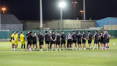 Palestine players gather around during a training session.